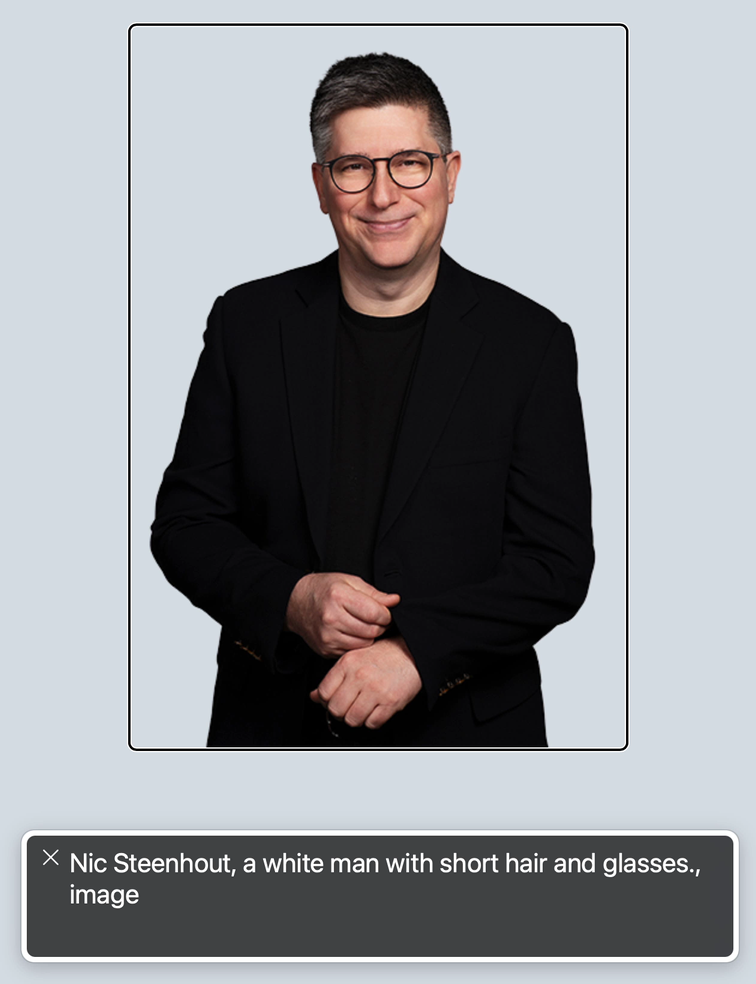 Screenshot of a photo from this website with VoiceOver Caption panel showing the text Nic Steenhout, a white man with short hair and glasses.